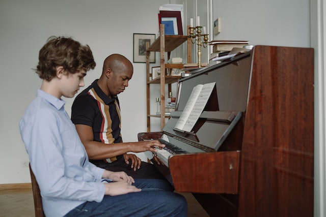 A boy learning the piano to be part of the music ministry.