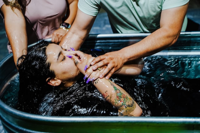 A woman being baptized.