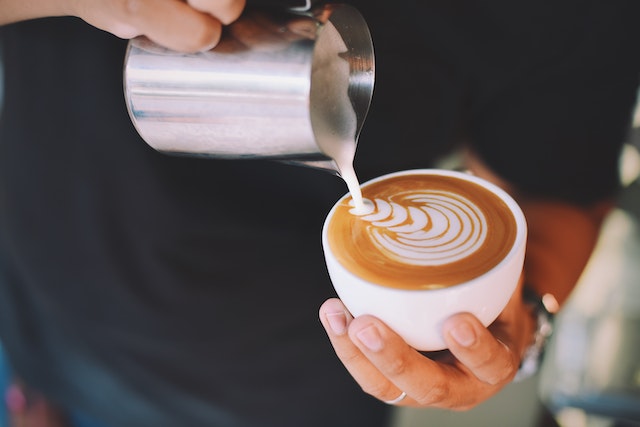 A barista doing latte art.