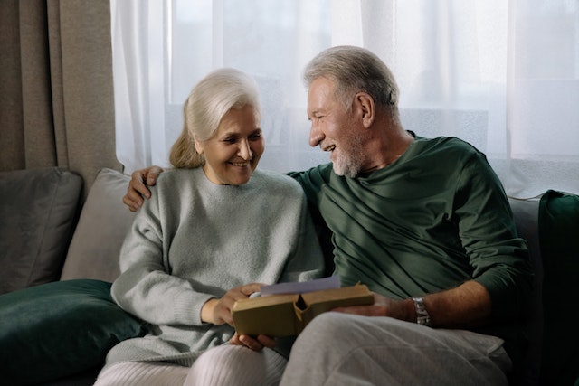 An old couple happily discussing Bible lessons on marriage to continue their strong relationship.