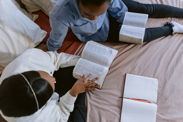 Two youths studying the Bible to develop a Christian mindset. 