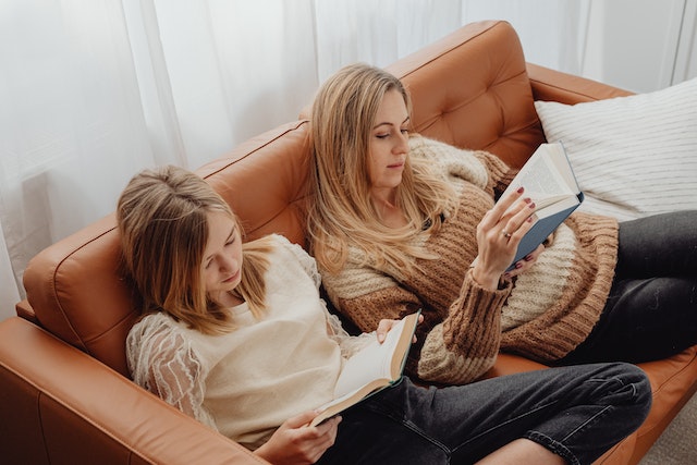 A mother and daughter reading the Bible.