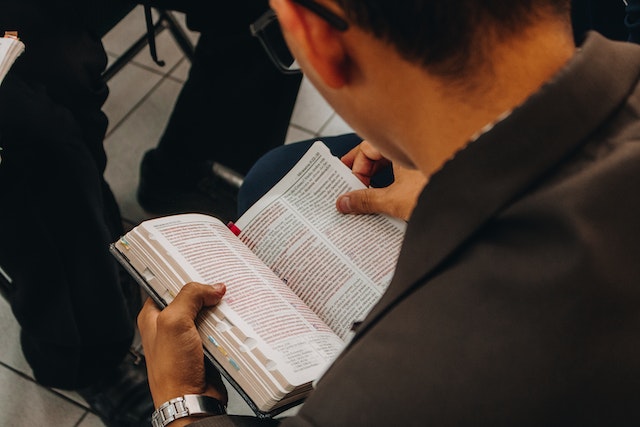 A man reading a book of the Bible