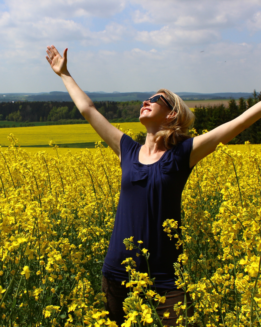 Woman in field of flowers looking up