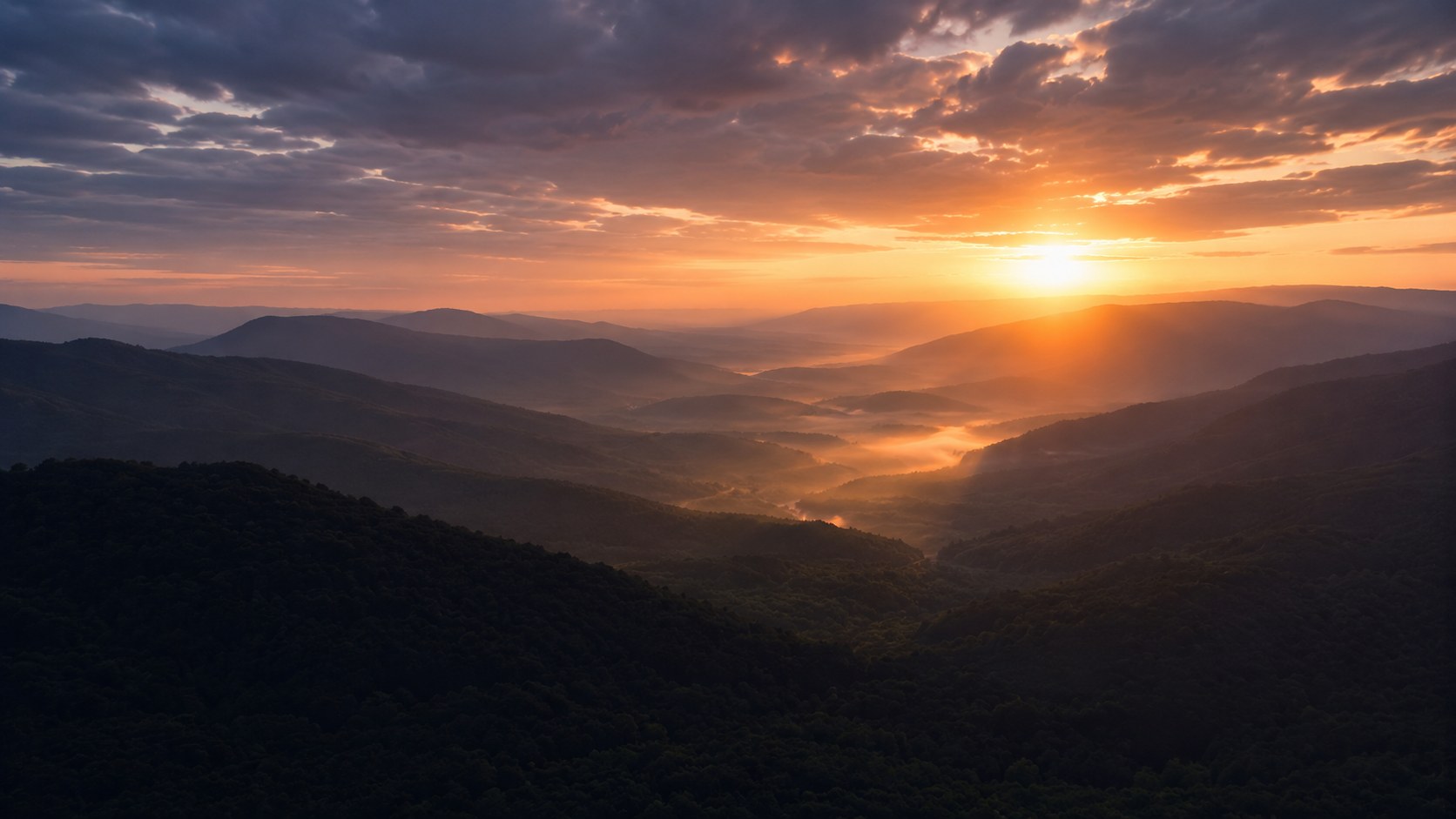 Dawn breaking over a dark valley, an image to accompany bible verses about fear