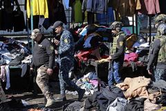 Suicide bombers attack Baghdad market
