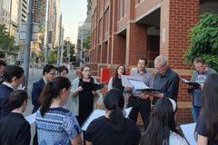 Christmas Eve carolers for Cardinal Pell gathered at Melbourne prison