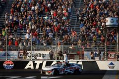 Liberty University car wins NASCAR race in Atlanta; Jerry Falwell Jr. celebrates
