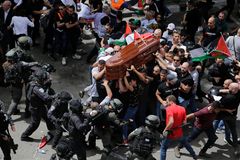 Israeli police clash with slain journalist’s mourners