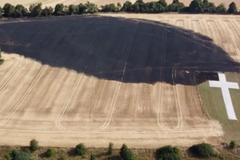 Memorial cross survives fire that swept through field during heatwave