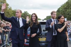 Harry and Meghan unexpectedly join William and Kate to greet crowds paying tribute to Queen Elizabeth II