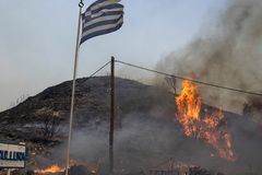 Wildfires burn across Greek islands
