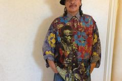 Carlos Santana retracts apology for saying 'a woman is a woman and a man is a man'