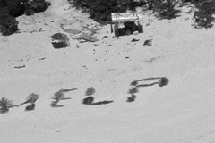 Castaways rescued from writing ‘help’ on island beach