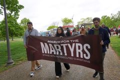 'Ask God for their protection': Demonstrators march through the rain to stand with persecuted Christians