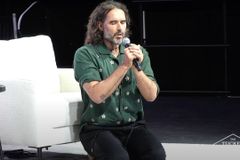 Russell Brand kneels in prayer at Tucker Carlson event, prays against 'dark and demonic forces'