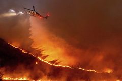 At least 10 die as wildfires blaze around Los Angeles