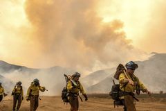Central California wildfire injures three, threatens homes