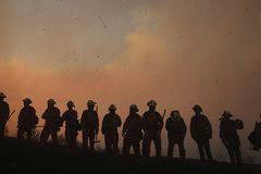 Thousands move, firefighters injured in California blazes