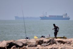 Evacuation paused in Strait of Hormuz after ship hit