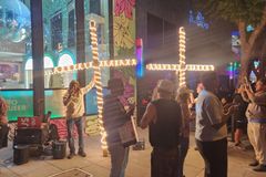 Street evangelist team assaulted by pedestrians in rainbow-painted sidewalk outside lesbian bar