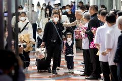 Flowers and face masks as Chinese tourists return to Thailand