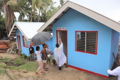 Caritas Cebu turns over 100 housing units to typhoon victims