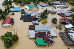 At least four dead, tens of thousands evacuated in Malaysia floods