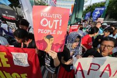 Environmental defenders protest at COP 28 in Dubai on international human rights day