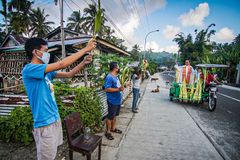 Priests bless palms on the streets as lockdown continues
