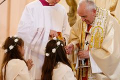 After offering instruction, pope gives first Communion to 245 children
